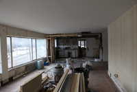 View of West end of livingroom kitchen overhang for future counter and door of back enclosed porch